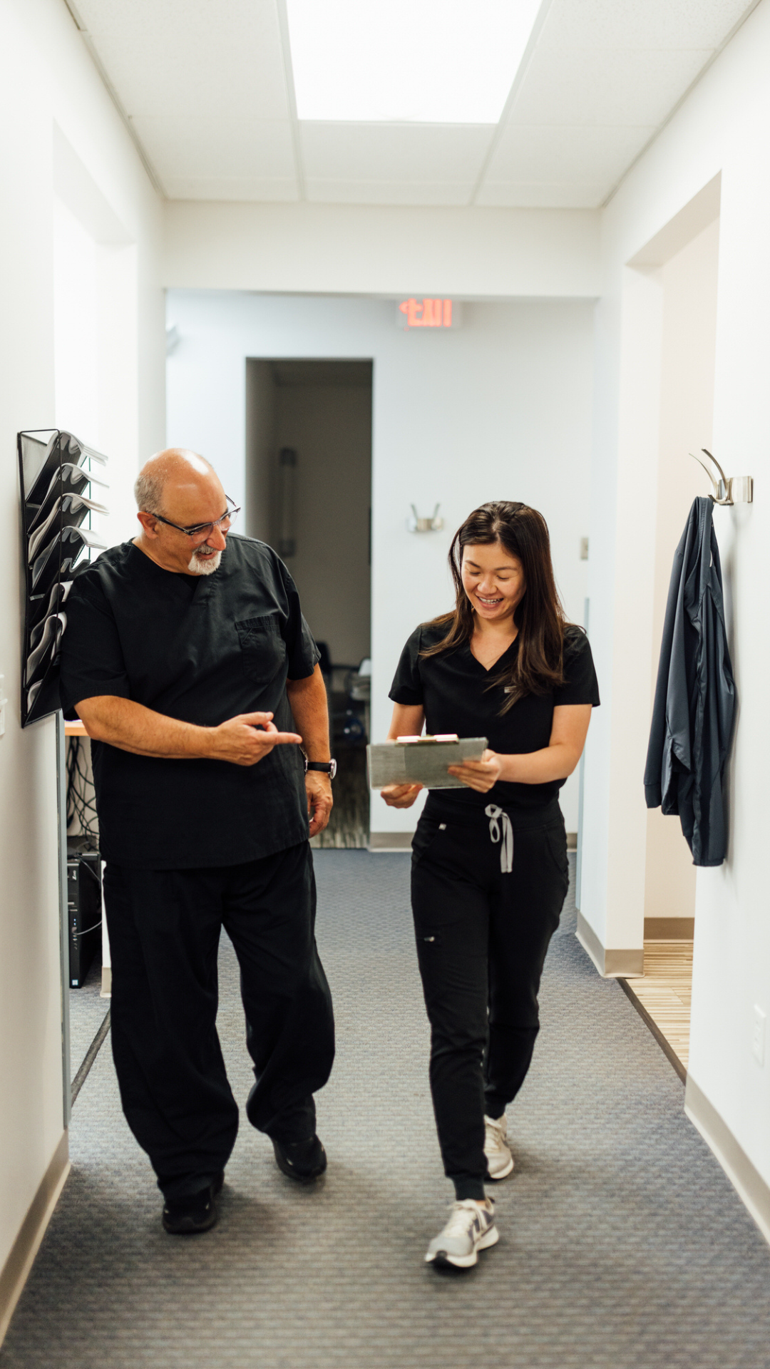 Dr. David Tartaglia and Dr. Srey Hun walking down the hall at Generations Dental in Poplar Grove, IL