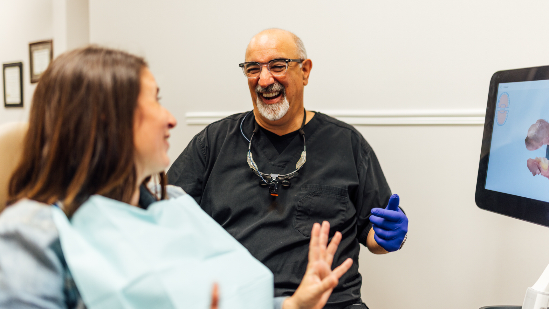 Dr. David Tartaglia laughing with his patient at Generations Dental in Poplar Grove, IL